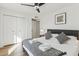 Well-lit bedroom features modern ceiling fan, closet doors, and hardwood flooring at 5232 E Everett Dr, Scottsdale, AZ 85254