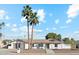 Charming single-story home with palm trees, gray trim, walkway, and landscaped front yard at 5232 E Everett Dr, Scottsdale, AZ 85254