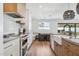 Modern kitchen features stainless steel appliances, white cabinets, and a large farmhouse sink at 5232 E Everett Dr, Scottsdale, AZ 85254