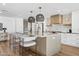 The kitchen island boasts modern hanging lights and barstool seating with a marble countertop at 5232 E Everett Dr, Scottsdale, AZ 85254