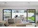 Bright living room featuring an open sliding glass door to a landscaped outdoor patio at 5232 E Everett Dr, Scottsdale, AZ 85254