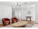 Comfortable living room with two rust colored chairs, modern lighting, and wood laminate flooring at 5232 E Everett Dr, Scottsdale, AZ 85254