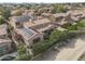 Aerial shot of homes with solar panels in a well-maintained desert neighborhood with mountain views at 5636 E Libby St, Scottsdale, AZ 85254