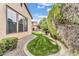 Well-maintained backyard featuring a lush lawn and a stone-lined garden bed, creating a serene outdoor space at 5636 E Libby St, Scottsdale, AZ 85254