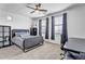 Bedroom featuring a gray bed frame, dark curtains, and an adjacent workspace at 5636 E Libby St, Scottsdale, AZ 85254