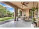 Inviting covered patio featuring stylish tile flooring, a ceiling fan, and elegant outdoor furnishings at 5636 E Libby St, Scottsdale, AZ 85254