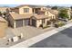 Aerial view of a two-story home with a tile roof, a paved driveway, and low maintenance desert landscaping at 5636 E Libby St, Scottsdale, AZ 85254