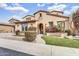 Inviting front entrance with lush landscaping and a decorative archway at 5636 E Libby St, Scottsdale, AZ 85254