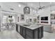 Open-concept kitchen featuring a large island, high-end appliances, and a view of the living area at 5636 E Libby St, Scottsdale, AZ 85254