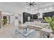 Bright open-concept living room with comfortable seating and modern kitchen featuring dark cabinetry at 5636 E Libby St, Scottsdale, AZ 85254