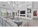 Stylish living room with a modern fireplace and a large sectional sofa at 5636 E Libby St, Scottsdale, AZ 85254