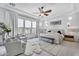 Large bedroom with seating area, large windows, and ceiling fan at 5636 E Libby St, Scottsdale, AZ 85254