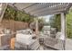 Outdoor living area featuring a built in barbeque with a seating area, a pergola, and an outdoor kitchen at 5636 E Libby St, Scottsdale, AZ 85254