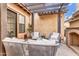 Inviting outdoor patio with comfortable seating, pergola, string lights, and charming desert landscaping at 5636 E Libby St, Scottsdale, AZ 85254