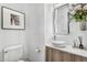 Stylish powder room boasts vessel sink, modern vanity, framed art, and elegant decorative accents at 5636 E Libby St, Scottsdale, AZ 85254