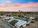 Stunning aerial view of a neighborhood with palm trees under a vibrant sunset sky at 6601 E Hearn Rd, Scottsdale, AZ 85254