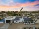 Scenic aerial view of a beautiful home nestled within a lush green landscape at sunset at 6601 E Hearn Rd, Scottsdale, AZ 85254