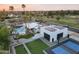 Wide angle aerial view of the backyard featuring a pool, putting green, and pickleball court at 6601 E Hearn Rd, Scottsdale, AZ 85254