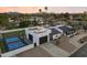 Aerial view of a modern home with a basketball court, solar panels, and a well-maintained yard at 6601 E Hearn Rd, Scottsdale, AZ 85254