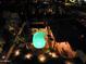 Aerial nighttime view of the sparkling, lighted pool and lush landscaping of this private backyard oasis at 6601 E Hearn Rd, Scottsdale, AZ 85254