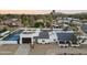 Overhead view of the home with a large yard featuring a basketball court, putting green, and lush landscaping at 6601 E Hearn Rd, Scottsdale, AZ 85254