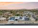 Aerial view of home with a pool and sports court nestled in a mature landscape neighborhood at 6601 E Hearn Rd, Scottsdale, AZ 85254