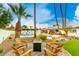 Backyard with a firepit surrounded by chairs and a swimming pool with outdoor seating at 6601 E Hearn Rd, Scottsdale, AZ 85254