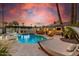 Outdoor view of backyard with a pool, spa, hammocks, and a covered patio under a vibrant sky at 6601 E Hearn Rd, Scottsdale, AZ 85254