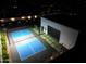 Aerial view of a modern basketball and pickleball court with a garage at night at 6601 E Hearn Rd, Scottsdale, AZ 85254