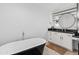 Modern bathroom featuring a black standalone tub, white cabinets, and sleek vanity at 6601 E Hearn Rd, Scottsdale, AZ 85254