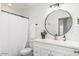 Bright bathroom featuring modern fixtures, a large mirror, and a shower with white tiling at 6601 E Hearn Rd, Scottsdale, AZ 85254