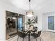 Cozy dining area with a glass table, stylish chairs, and natural light from the sliding door at 6601 E Hearn Rd, Scottsdale, AZ 85254