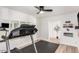 Spacious exercise room with wall mirrors, hardwood floors, wall mounted television, and modern treadmill at 6601 E Hearn Rd, Scottsdale, AZ 85254