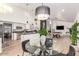 Modern kitchen with stainless steel appliances connected to open concept dining and entertaining areas at 6601 E Hearn Rd, Scottsdale, AZ 85254