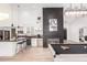 Modern kitchen and living area featuring granite counters, stainless steel appliances, and a game room at 6601 E Hearn Rd, Scottsdale, AZ 85254