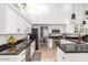 Well-lit kitchen showcasing stainless steel appliances, and black countertops at 6601 E Hearn Rd, Scottsdale, AZ 85254