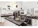 Well-equipped kitchen featuring a large island, black countertops, and a wine cooler at 6601 E Hearn Rd, Scottsdale, AZ 85254