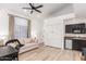 Comfortable living room with a large window, ceiling fan, kitchenette, and hardwood floors at 6601 E Hearn Rd, Scottsdale, AZ 85254