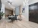 Open living room with modern lighting, a sleek sofa, and a view into the dining area at 6601 E Hearn Rd, Scottsdale, AZ 85254