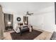 Stylishly appointed main bedroom with wooden floors, ceiling fan, black and gold accents, and ample natural light at 6601 E Hearn Rd, Scottsdale, AZ 85254