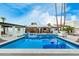 Swimming pool with a swan floatie and views of the covered patio and nearby lounge seating at 6601 E Hearn Rd, Scottsdale, AZ 85254