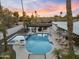 Inviting pool area with a covered outdoor kitchen and spa, perfect for relaxation and entertaining, at sunset at 6601 E Hearn Rd, Scottsdale, AZ 85254