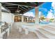 Poolside bar featuring a built-in grill, seating, and a covered area overlooking the pool at 6601 E Hearn Rd, Scottsdale, AZ 85254