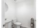 Functional powder room featuring a pedestal sink, toilet, and storage solutions at 6601 E Hearn Rd, Scottsdale, AZ 85254