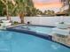 Swimming pool with stone waterfall features and a well-maintained surrounding landscape at 6601 E Hearn Rd, Scottsdale, AZ 85254