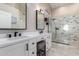 Stylish bathroom featuring double sinks, white vanity, and a glass shower at 662 W Raven Dr, Chandler, AZ 85286