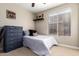 Cozy bedroom with neutral walls, window, and a chest of drawers at 662 W Raven Dr, Chandler, AZ 85286