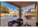 Covered patio with outdoor seating overlooking a pool and backyard at 662 W Raven Dr, Chandler, AZ 85286