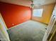 Cozy bedroom with carpet, a window, ceiling fan, and a warm accent wall at 6727 E Stacy St, Florence, AZ 85132