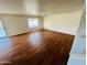 Spacious living room featuring wood-look flooring, a ceiling fan, and a sliding glass door at 6727 E Stacy St, Florence, AZ 85132